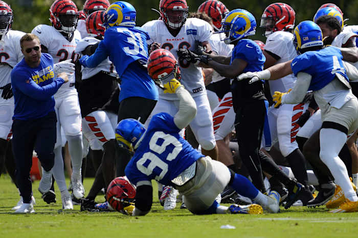 Los Angeles Rams defensive tackle Aaron Donald (99) is knocked to the ground as a third scuffle escalates into a brawl during a joint preseason camp practice between the Cincinnati Bengals and the Los Angeles Rams.